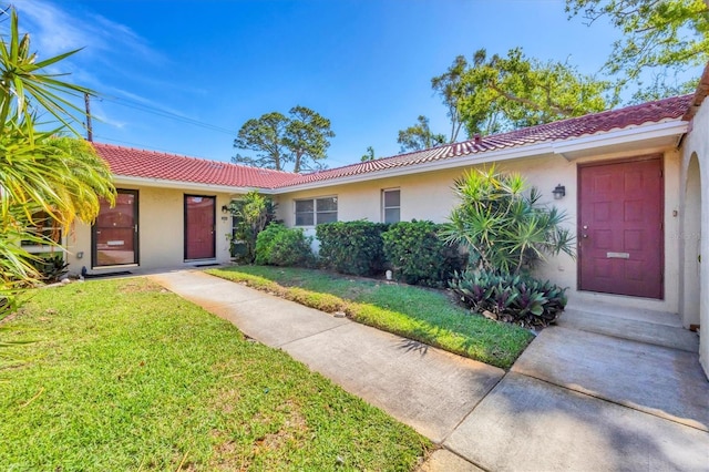 2267 Pueblo Ln Unit V40, Sarasota, FL 34231 - single story home featuring a tile roof, stucco siding, and a front yard