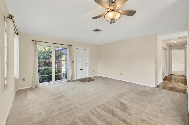 2267 Pueblo Ln Unit V40, Sarasota, FL 34231 - unfurnished living room featuring baseboards, carpet floors, and a ceiling fan
