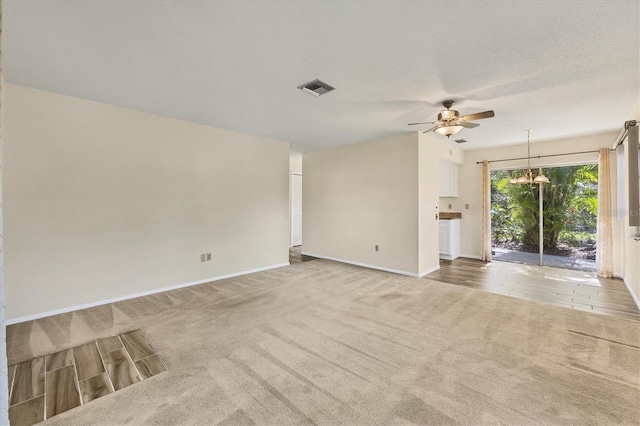 2267 Pueblo Ln Unit V40, Sarasota, FL 34231 - spare room featuring carpet flooring, a ceiling fan, baseboards, and a chandelier