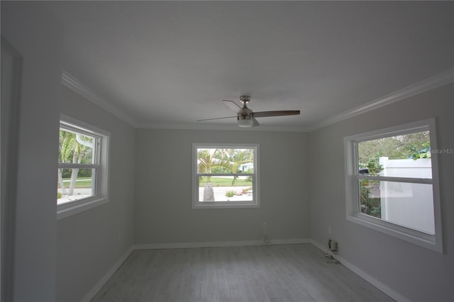 306 Island Cir, Sarasota, FL 34242 - spare room with crown molding, light wood finished floors, and a wealth of natural light