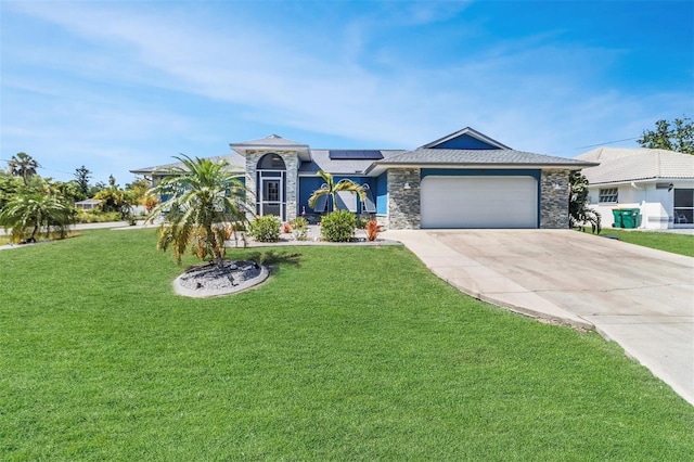23088 Allen Ave, Port Charlotte, FL 33980 - ranch-style home featuring stone siding, concrete driveway, roof mounted solar panels, and a front yard