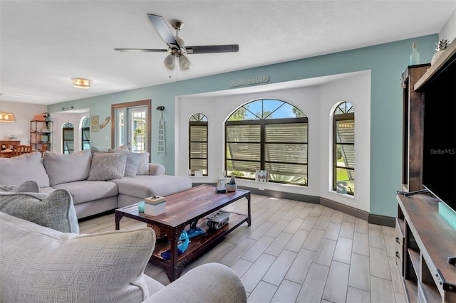 23088 Allen Ave, Port Charlotte, FL 33980 - living room featuring healthy amount of natural light, a ceiling fan, and wood tiled floors