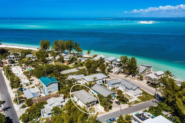 birds eye view of property featuring a water view and a view of the beach