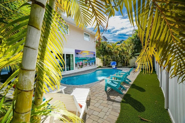 view of pool featuring a patio area, a fenced backyard, and a fenced in pool