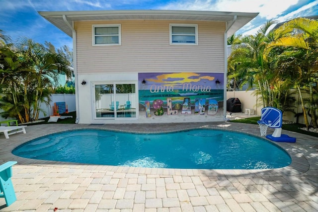 view of swimming pool featuring a patio area, fence, and a fenced in pool