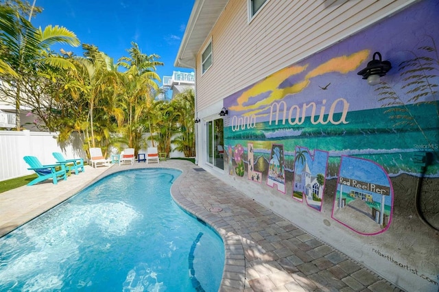 view of swimming pool with a patio area, fence, and a fenced in pool