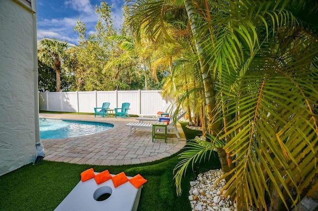 view of swimming pool featuring a fenced backyard, a fenced in pool, and a patio