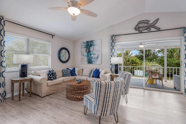 living room featuring a ceiling fan, plenty of natural light, and lofted ceiling