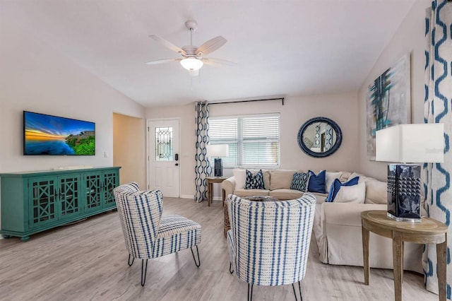 living room featuring ceiling fan, wood finished floors, vaulted ceiling, and baseboards