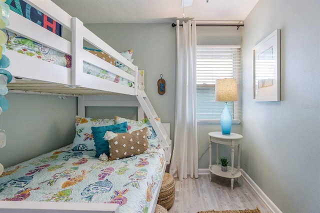bedroom with baseboards and wood finished floors