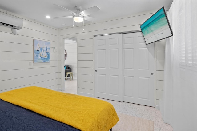 bedroom with a closet, speckled floor, a ceiling fan, recessed lighting, and a wall mounted AC