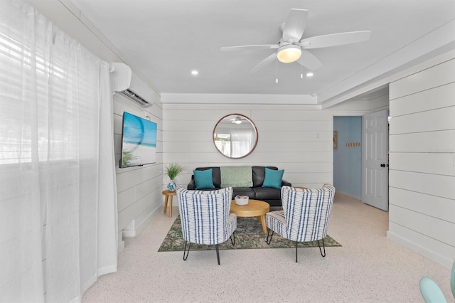 living area featuring recessed lighting, a wall unit AC, speckled floor, and ceiling fan