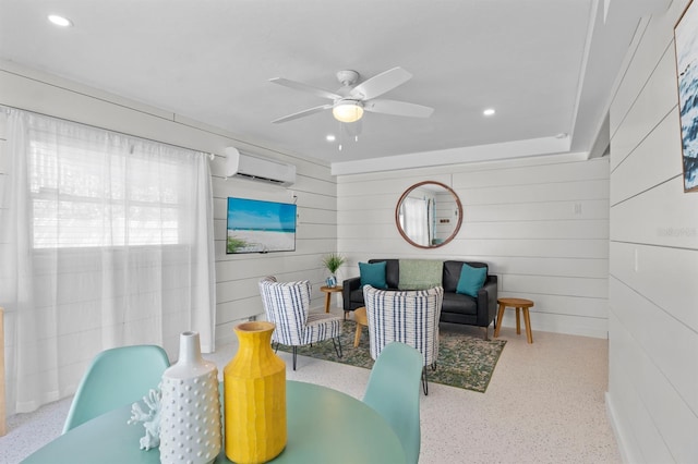 dining space with speckled floor, recessed lighting, and a wall unit AC