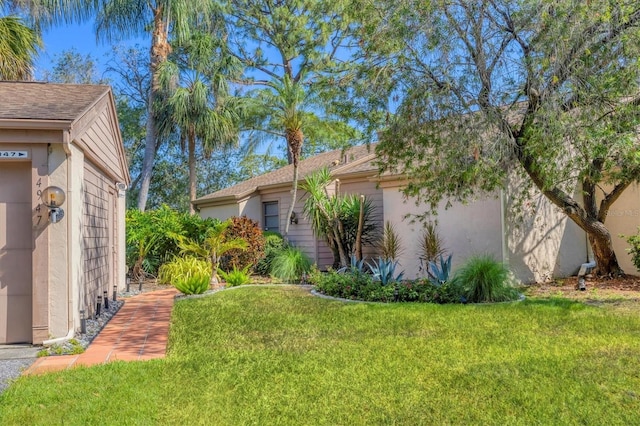 4947 Greencroft Rd Unit 175, Sarasota, FL 34235 - view of side of property with a lawn and stucco siding