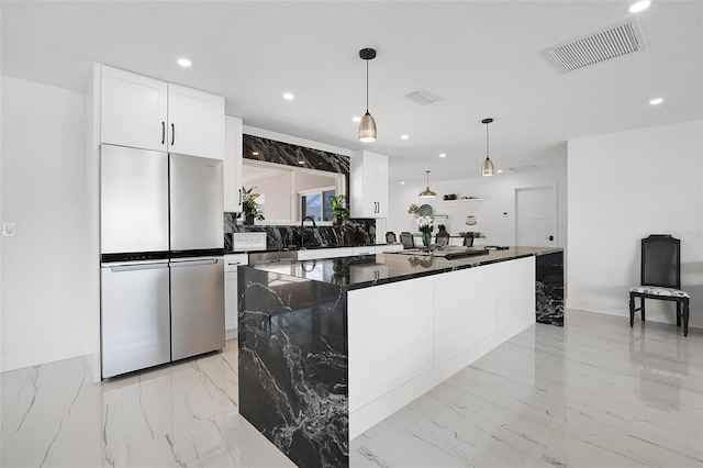 kitchen with recessed lighting, white cabinetry, freestanding refrigerator, visible vents, and marble finish floor