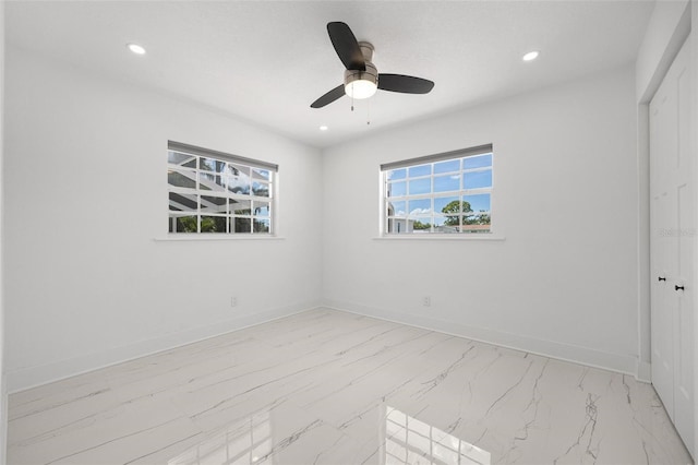 unfurnished bedroom with recessed lighting, marble finish floor, and baseboards