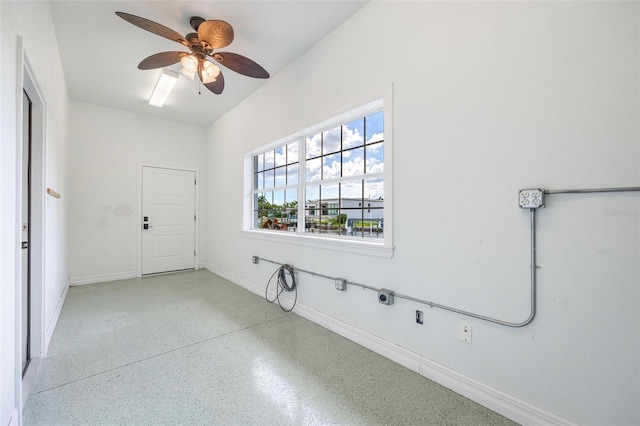 clothes washing area featuring baseboards and a ceiling fan
