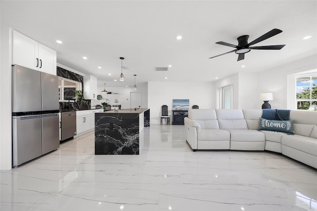 living area featuring recessed lighting, visible vents, marble finish floor, and a ceiling fan