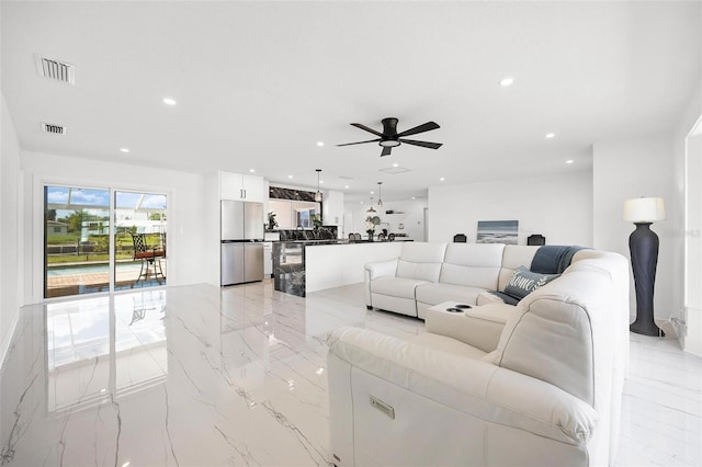 living room featuring recessed lighting, visible vents, and a ceiling fan