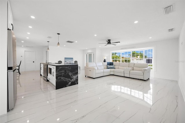 living room featuring recessed lighting, visible vents, and marble finish floor