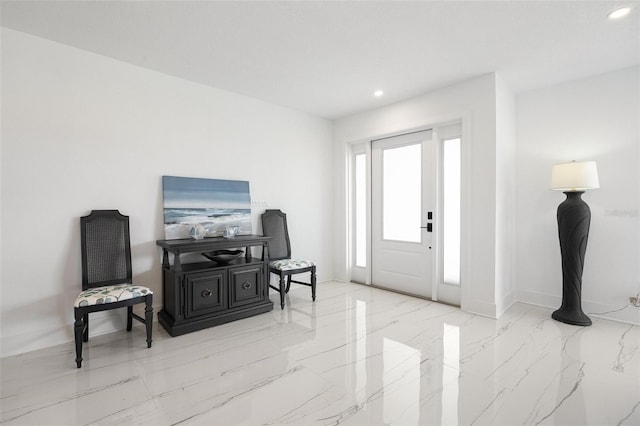 foyer entrance featuring marble finish floor, baseboards, and recessed lighting