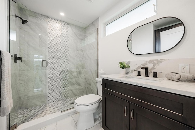 bathroom featuring a shower stall, vanity, marble finish floor, and toilet