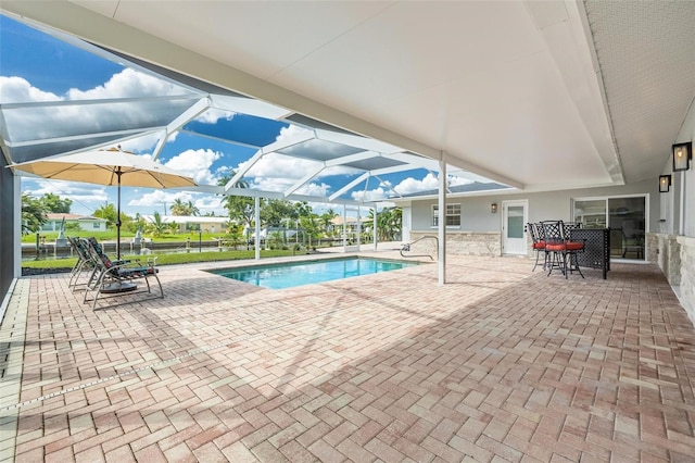 pool with a patio area and glass enclosure