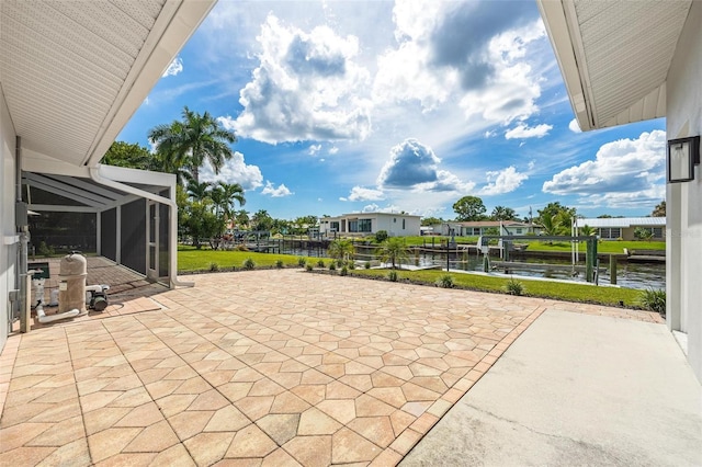 view of patio featuring a dock, a water view, boat lift, and a lanai