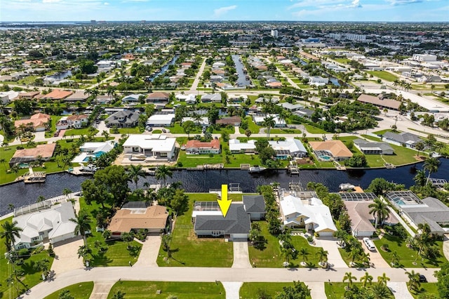 birds eye view of property featuring a water view and a residential view