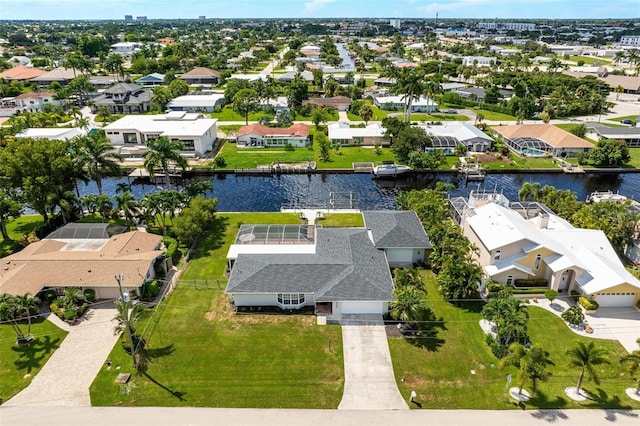 drone / aerial view with a water view and a residential view