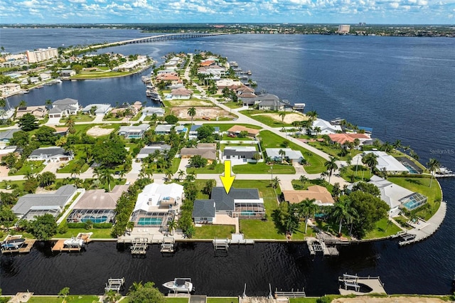 birds eye view of property featuring a water view and a residential view