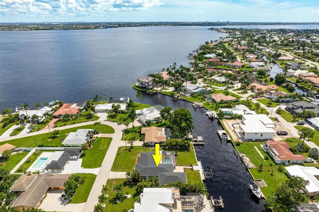 bird's eye view featuring a water view and a residential view