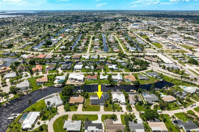 drone / aerial view featuring a residential view and a water view