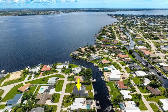 drone / aerial view featuring a water view and a residential view