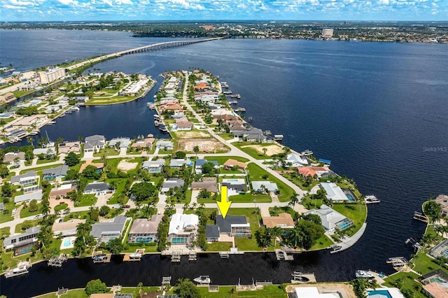 drone / aerial view featuring a residential view and a water view