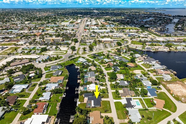 drone / aerial view featuring a water view and a residential view
