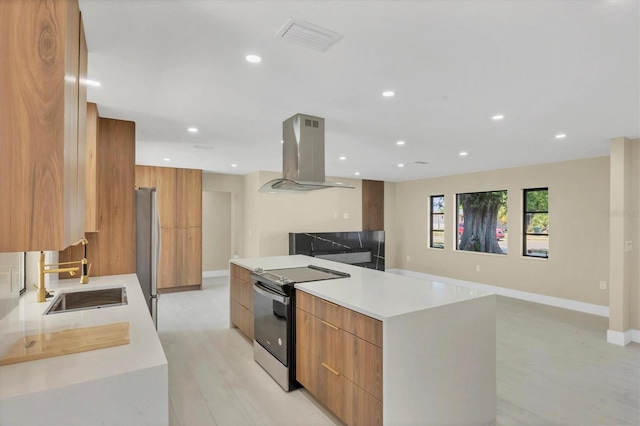 kitchen featuring island exhaust hood, electric stove, a sink, and modern cabinets