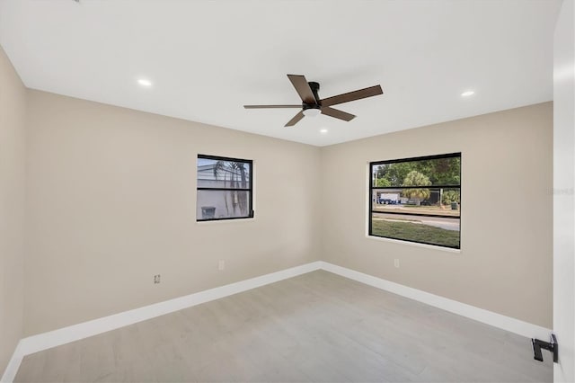 unfurnished room featuring wood finished floors, a ceiling fan, baseboards, and recessed lighting