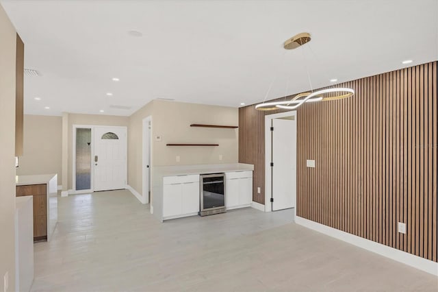 kitchen featuring recessed lighting, white cabinetry, modern cabinets, open shelves, and beverage cooler