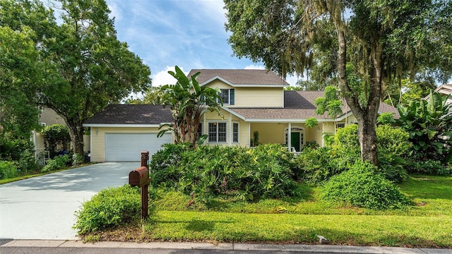 view of front of house featuring concrete driveway and an attached garage