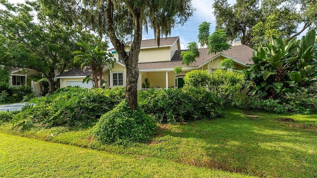 view of front of house featuring a garage and a front lawn