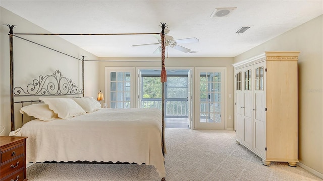 bedroom with visible vents, light colored carpet, and access to outside