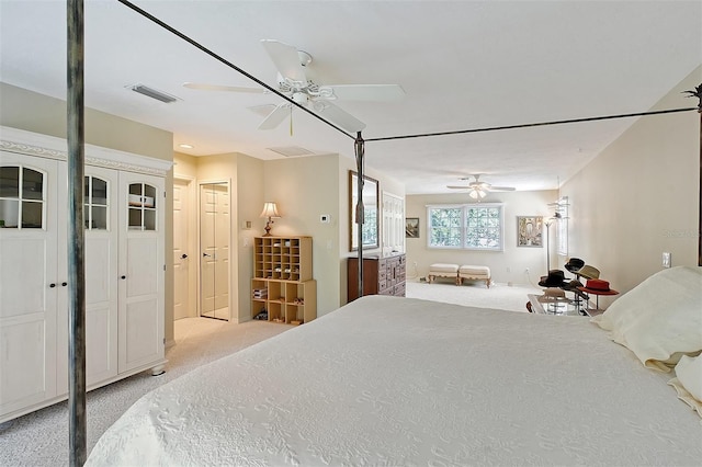 bedroom with light carpet, a ceiling fan, and visible vents