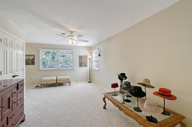 bedroom with visible vents, light carpet, a ceiling fan, and baseboards