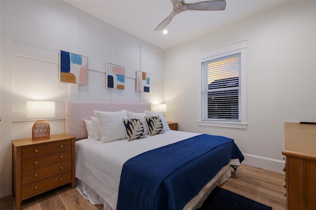 bedroom featuring ceiling fan, recessed lighting, wood finished floors, and baseboards
