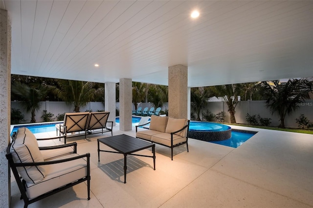 view of pool with a fenced backyard, a pool with connected hot tub, a patio, and an outdoor hangout area