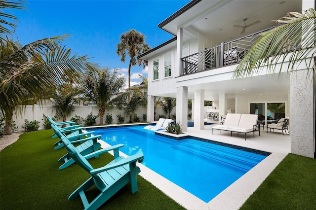view of swimming pool featuring ceiling fan, a fenced backyard, an outdoor living space, a patio, and a fenced in pool