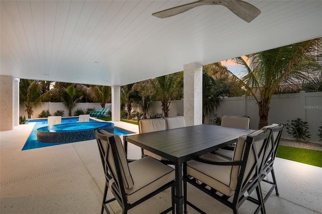 view of patio / terrace featuring outdoor dining space, a fenced backyard, a ceiling fan, and a fenced in pool