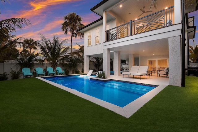 view of pool with a fenced in pool, a patio area, a fenced backyard, and a lawn