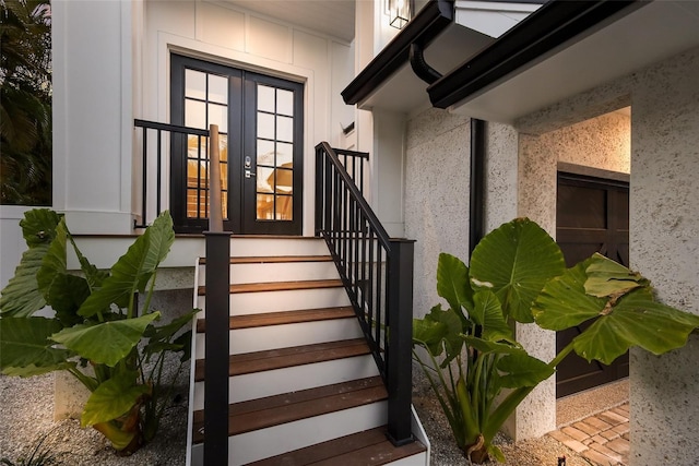 entrance to property featuring french doors and stucco siding